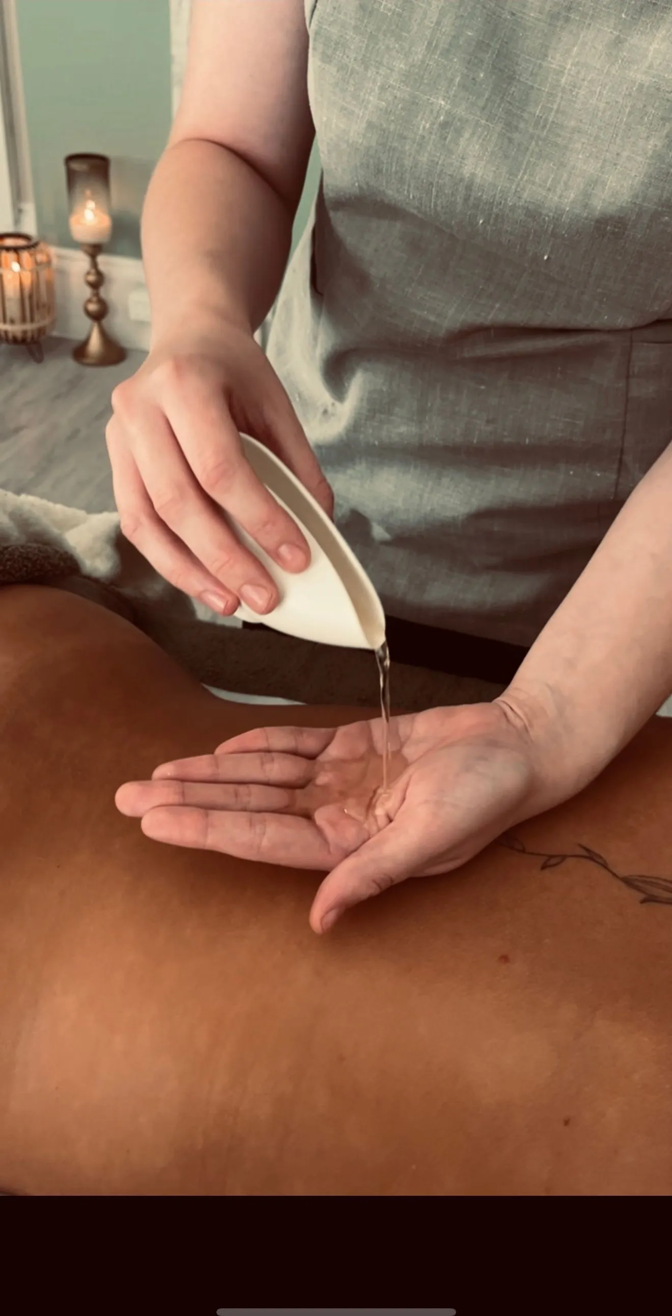 Massage oil being poured - relaxing spa treatment